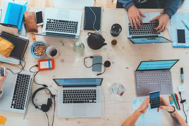 People at the table on laptops