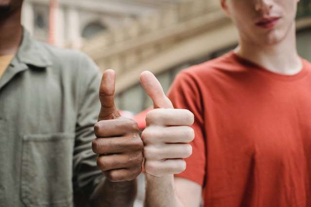 Two people giving a thumbs up